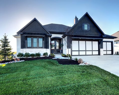 Image of a single-family, single-story custom home in Johnson County, Kansas, large windows in the front and a l-shaped Gable roof